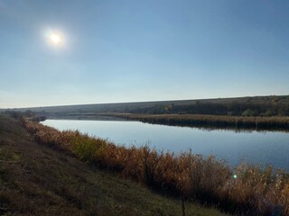 Autumn river landscape. Autumn river and clear blue sky. Sky river in autumn. Autumn river view