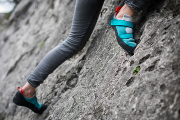 Person climbing while wearing rock climbing shoes