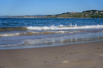 Sunny scenery of a sandy beach in the Oyambre natural park in San Vicente de la Barque
