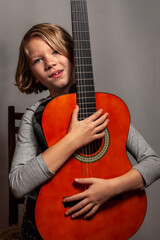 little girl with guitar on grey background