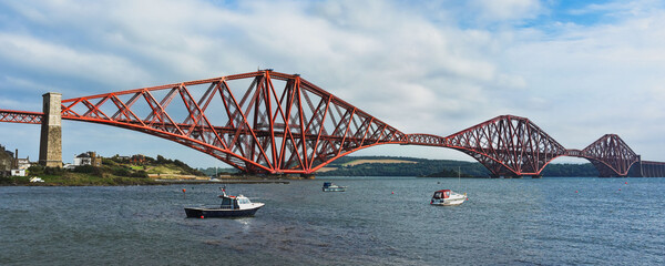 The red painted Forth Rail Bridge stretches from the harbor at North Queensferry across the Firth...