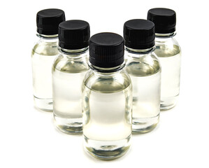 several bottles with black caps filled with transparent liquid.