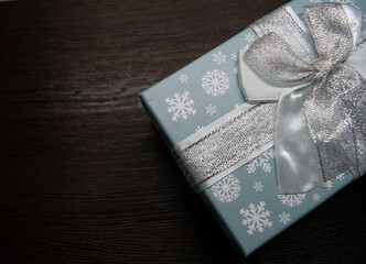 gift box with a bow and snowflakes on a dark background