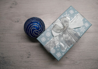 gift box with snowflakes and a blue Christmas ball