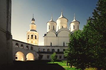 medieval cathedral and the bell tower in the rays of the setting sun