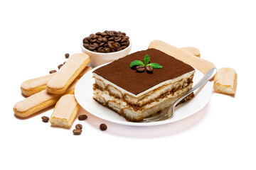 Traditional Italian Tiramisu square dessert portion on ceramic plate, savoiardi cookies and coffee beans isolated on white
