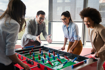 Coworkers playing table football on break from work