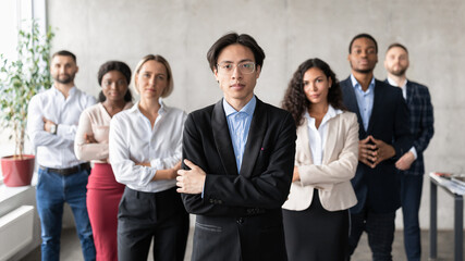 Asian Businessman Posing Standing With His Employees Team In Office