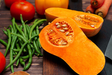 Raw orange pumpkin and wooden cutting board