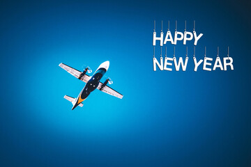 The plane flies on a blue background with the inscription Happy new year.