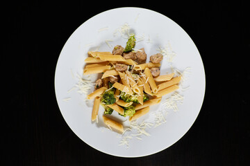 photography of a plate of macaroni with broccoli and sausages