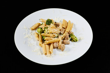 photography of a plate of macaroni with broccoli and sausages