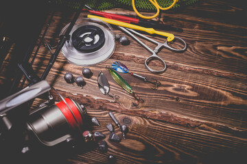 Fishing tackle on a wooden background. Studio photo.