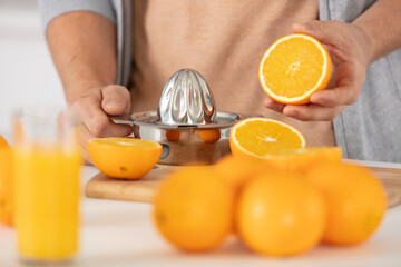 closeup on woman making orange juice