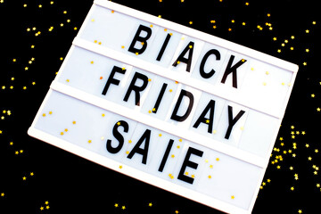 Lightbox on a black background with golden stars and the inscription black friday sale.