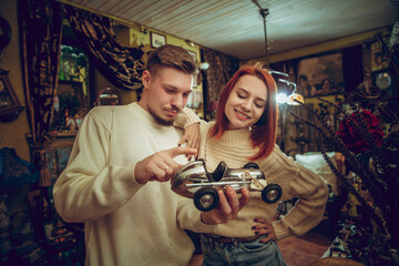 Car. Smiling family, caucasian couple looking for home decoration and holiday's gifts in household store. Stylish and retro things for greetings or design. Interior renovation, celebrating time.