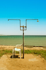 Fototapeta na wymiar Beach Shower with Chair