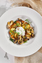 Fried potato with mushrooms and sour cream