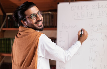 Happy Indian Teacher Man Teaching English Language Online At Home