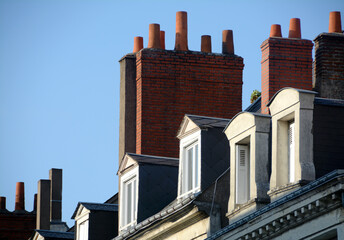 the typical roofs of French palaces full of colorful fireplaces and attics with windows