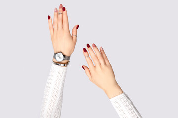 Beautiful womans hand with a pink manicure in minimal style