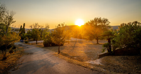 Clear sky over a country road at sunset