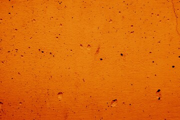 Macro Close up of cement concrete wall orange color texture abstract background with cracked small hole. style material for interior or exterior of building