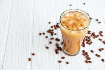 .Iced coffee in a glass On a white wooden background