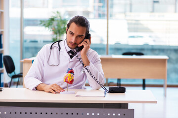 Young male doctor cardiologist working in the clinic