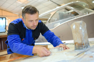 a man is working with fibreglass