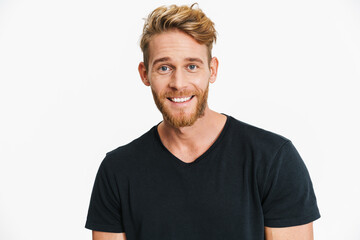 Pleased caucasian blonde man posing and smiling at camera