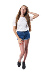 Fototapeta premium Full length of casual teen girl posing over white background