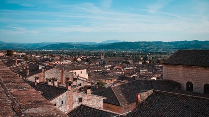 Fototapeta na wymiar Panoramic view from above of the medieval Italian village of Gubbio with old buildings (Umbria, Italy, Europe)