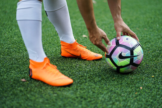Bangkok / Thailand - June 2018 : Football player training on artificial grass field. Wearing Nike Mercurial Superfly VI, the famous football boots for speedy player like Cristiano Ronaldo and Neymar. 