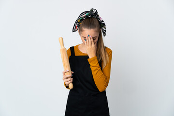 Young Lithuanian woman holding a rolling pin isolated on white background with tired and sick expression