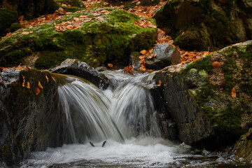 Small waterfalls in the bed of the Sestil de Maíllo stream. Autumn in the Sierra de Guadarrama National Park. Madrid's community. Spain