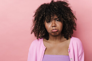 Unhappy african american woman posing and looking at camera