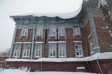 Ornamental carved windows, frames on N.D. Rodyukov's old wooden house on Karl Marx Street, 31,...