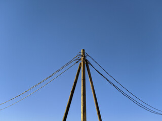electric pole with wires against the blue sky