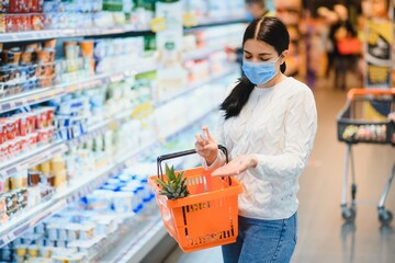 Woman wearing protective mask preparing for virus pandemic spread quarantine.Hygiene, cleaning and disinfection products.Preventive measures and protection.Supply shopping during the epidemic.