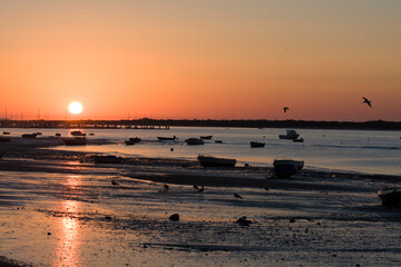 beautiful sunrise on a beach with boats