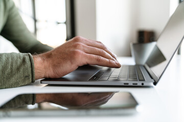 Close up of a businessman typng on laptop computer