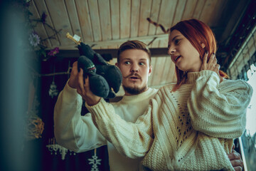 Handmade. Smiling family, caucasian couple looking for home decoration and holiday's gifts in household store. Stylish and retro things for greetings or design. Interior renovation, celebrating time.