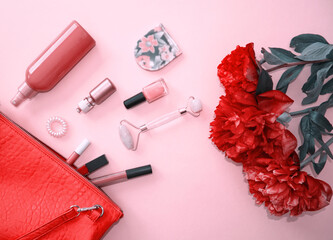 Fashion, cosmetics accessories, lipsticks, serum, facial roller, nail polish and tonic with red...
