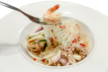 Spicy Glass Noodle Salad with Squid on white plate.