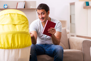 Young male contractor looking after new born at home