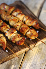 Appetizing chicken skewers on wooden sticks.