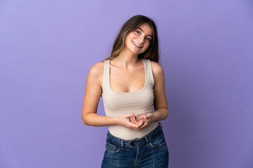 Young caucasian woman isolated on purple background laughing