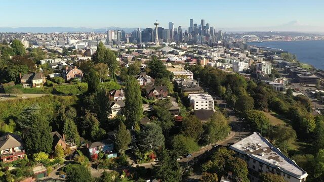 Aerial / drone orbiting reveal footage of West Queen Anne, Bellltown, downtown Seattle, upscale, affluent neighborhoods uptown by Puget Sound, in Seattle, Washington