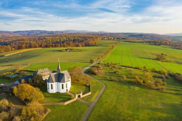 Bird's eye view of the idyllic Kreuzkapelle near Bad Camberg / Germany in the best autumn weather